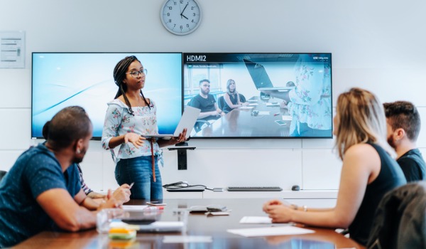 colleagues-discussing-in-meeting-room-during-video-conference-picture-id1211197186