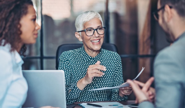 senior-businesswoman-talking-to-her-team-picture-id1178385552